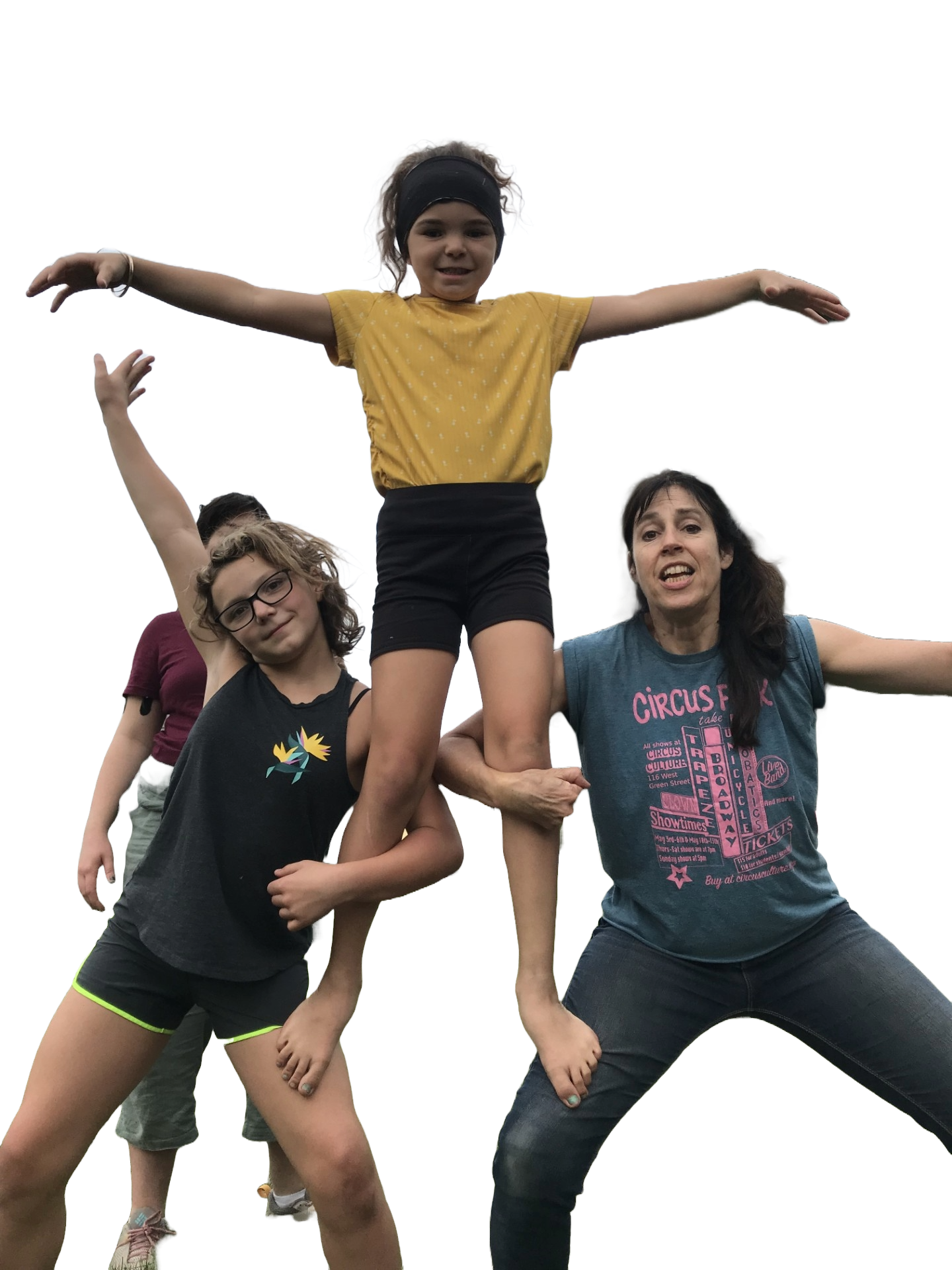 Three people form a pyramid with one standing on the legs of two in a lunge.